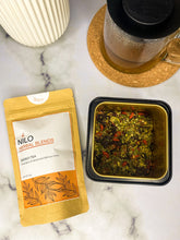 Load image into Gallery viewer, Energy tea product in orange package with loose leaf herbs and a mug of tea
