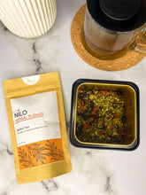 Load image into Gallery viewer, Energy tea product in orange package with loose leaf herbs and a mug of tea
